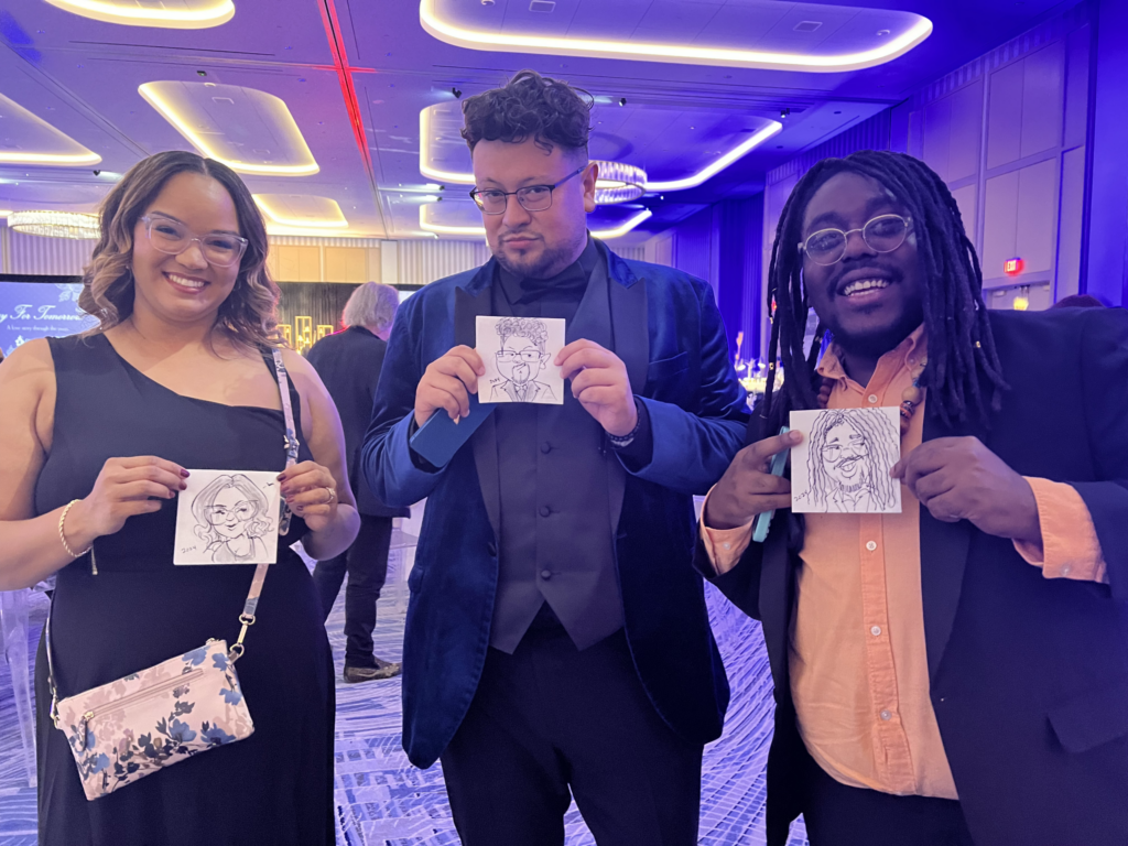 Event guests holding napkin caricatures